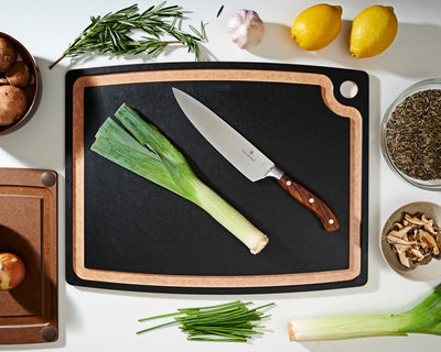 Gourmet Series Cutting Board in Slate with a Victorinox Chef's Knife Preparing To Cut Assorted Vegetables