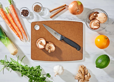 Epicurean Kitchen Series Cutting Board in Nutmeg with fruits and vegetables ready to be sliced with a Victorinox Chef's Knife