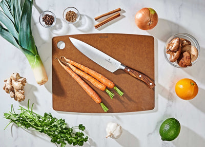 Epicurean Kitchen Series Cutting Board in Nutmeg with fruits and vegetables ready to be sliced with a Victorinox Chef's Knife