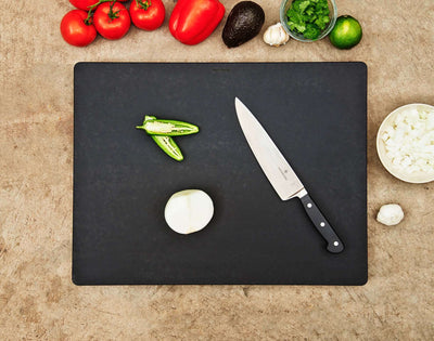 The Big Block Board in Slate with a Natural Cascade being used to slice fresh produce.