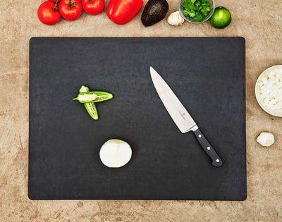 The Big Block Board in Slate with a Natural Cascade being used to slice fresh produce.